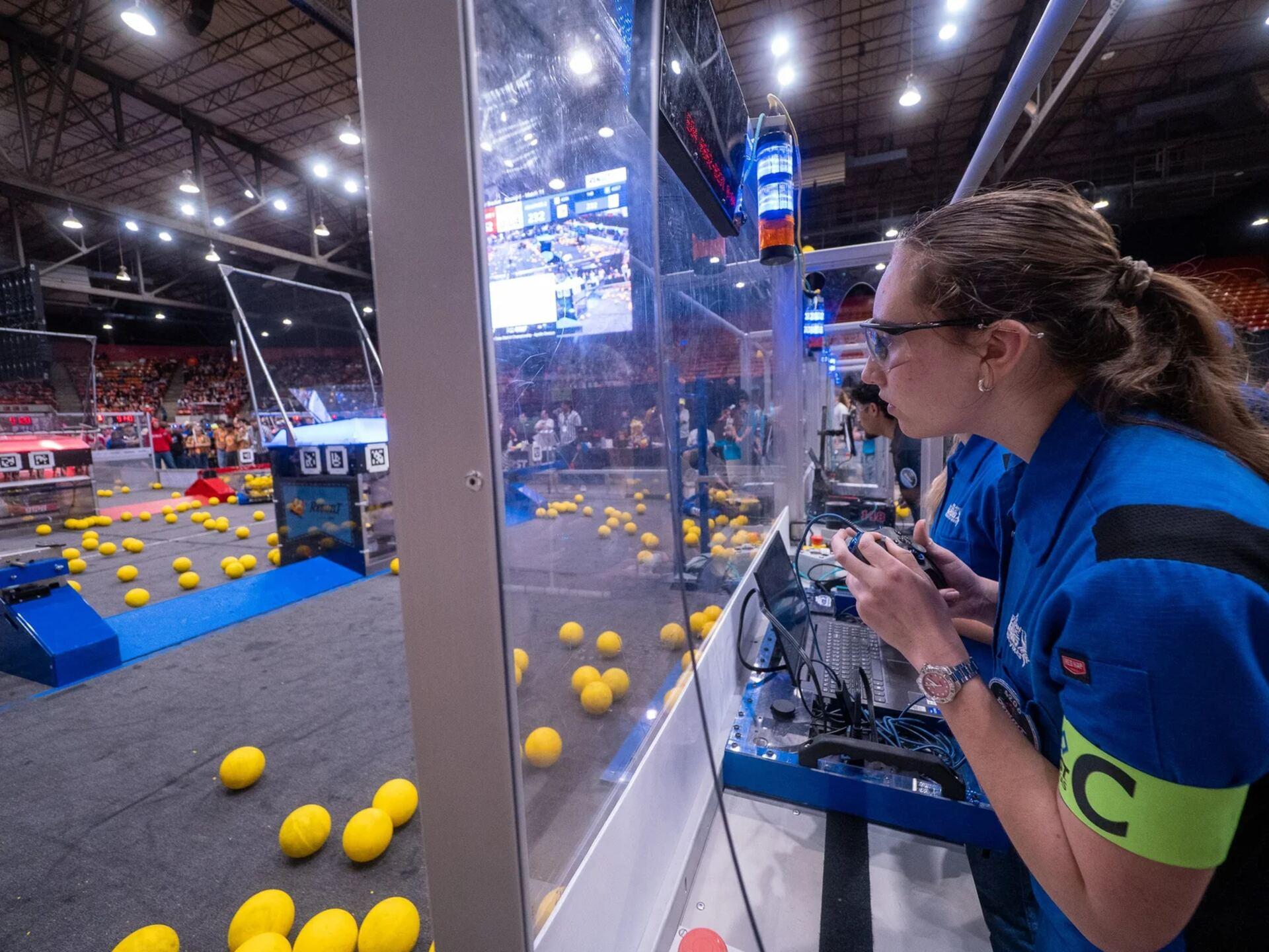 FIRST Robotics Competition robots competing on the field at a Texas district event